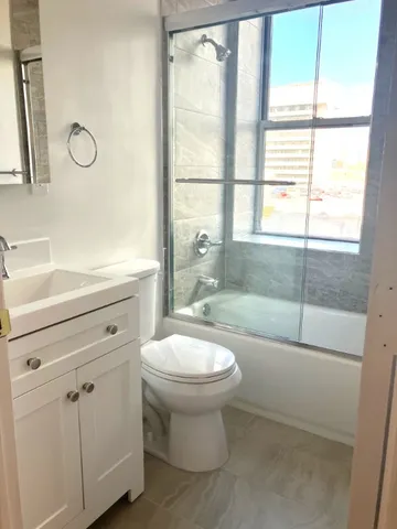 a bathroom with a sink a toilet and a shower