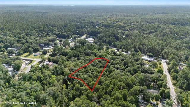 an aerial view of house with yard and mountain view in back