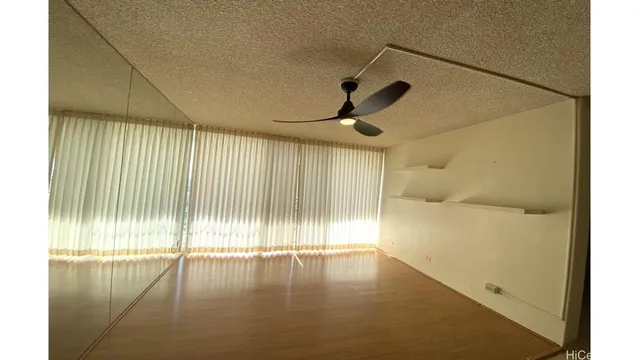 a view of a hallway with wooden shelves