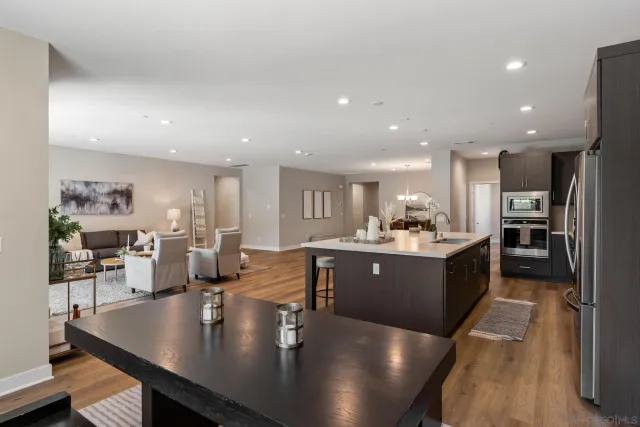 a large kitchen with lots of counter space dining table and chairs