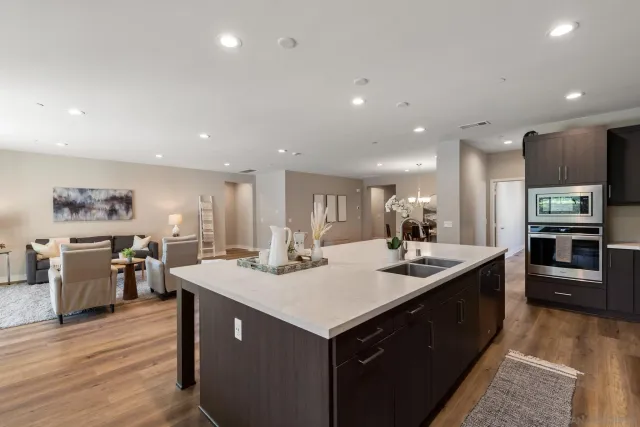a kitchen with a sink counter top space and stainless steel appliances