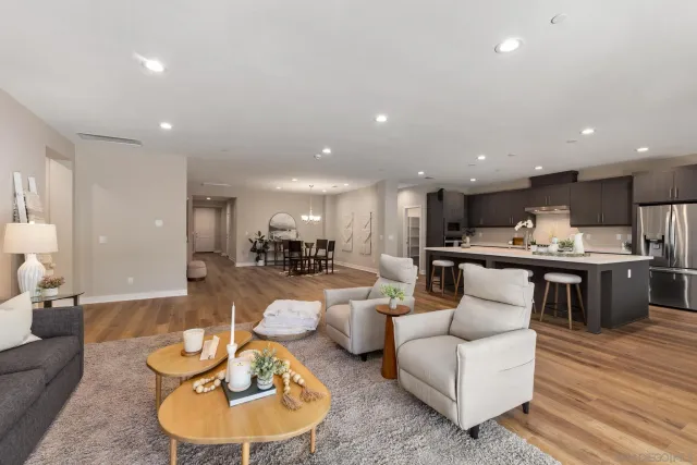 a living room with furniture kitchen and a table