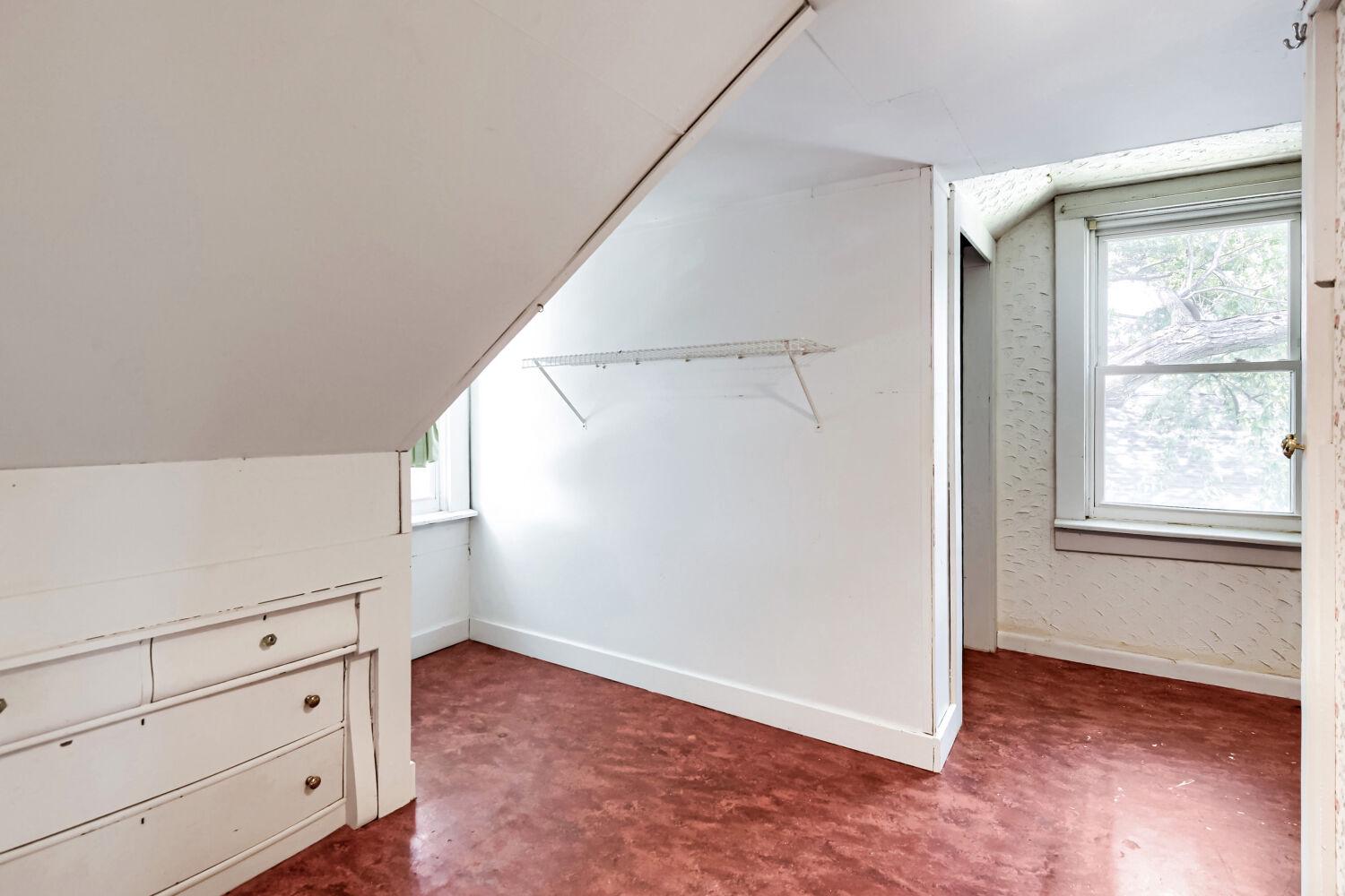 217 Doris Avenue Baltimore, MD 21225 - Photo 15 of 16 a view of an empty room with wooden floor and a window
