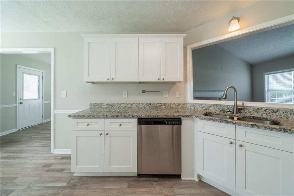 40 Princeton Court Covington, GA 30016 - Photo 13 of 31 a kitchen with granite countertop a sink and cabinets
