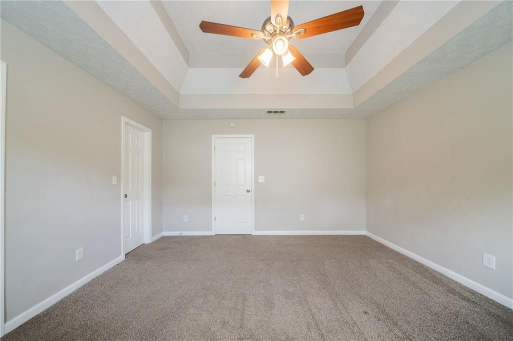 40 Princeton Court Covington, GA 30016 - Photo 16 of 31 an empty room with a ceiling fan and wooden floor