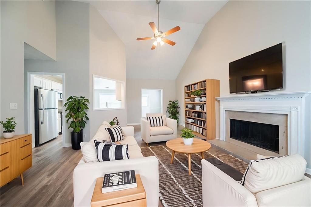 40 Princeton Court Covington, GA 30016 - Photo 3 of 31 a living room with furniture a flat screen tv and a fireplace