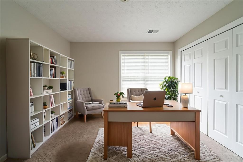 40 Princeton Court Covington, GA 30016 - Photo 5 of 31 a view of a workspace with furniture and a window