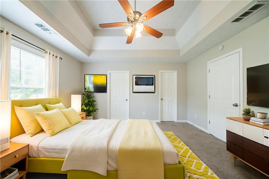 40 Princeton Court Covington, GA 30016 - Photo 6 of 31 a bedroom with a bed and a flat tv screen on dresser