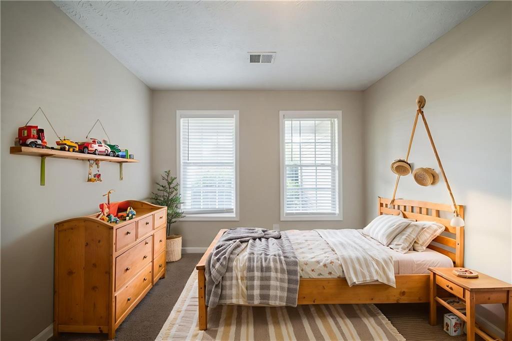 40 Princeton Court Covington, GA 30016 - Photo 7 of 31 a bedroom with a bed and a window