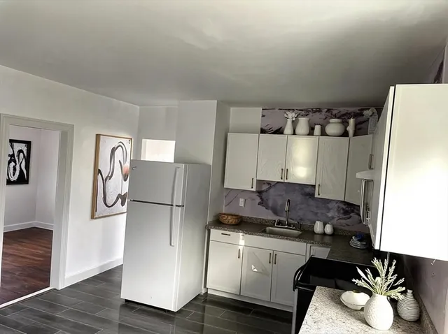 a kitchen with a refrigerator and a stove