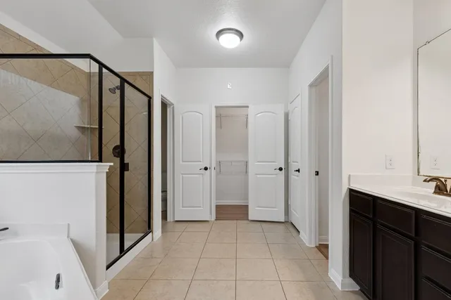 a bathroom with a shower and a sink