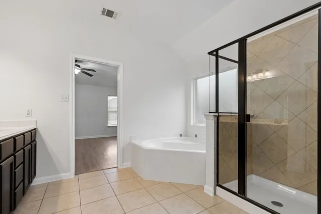 a bathroom with a bathtub and a shower