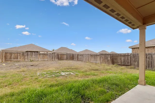 a front view of a house with a yard and fence