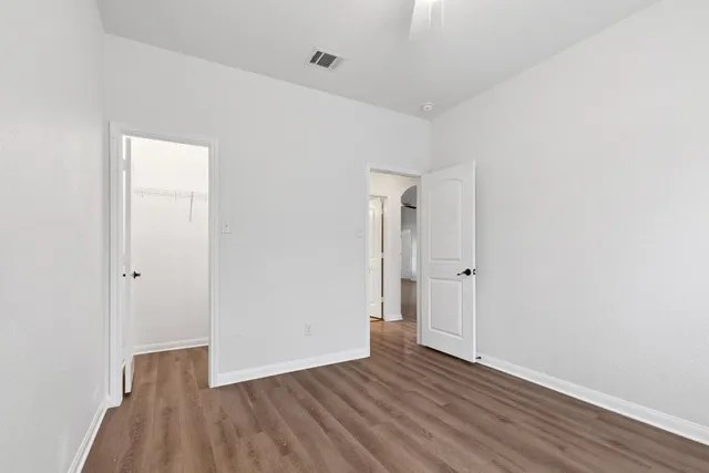 a view of an empty room and wooden floor