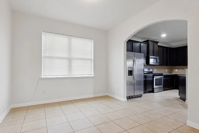 a kitchen with stainless steel appliances a refrigerator and a stove top oven