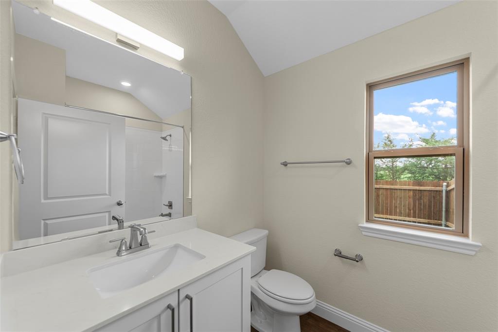 200 Pennington Road Josephine, TX 75173 - Photo 11 of 22 Contemporary bathroom featuring a single vanity with an integrated sink, white countertop, and brushed nickel faucet