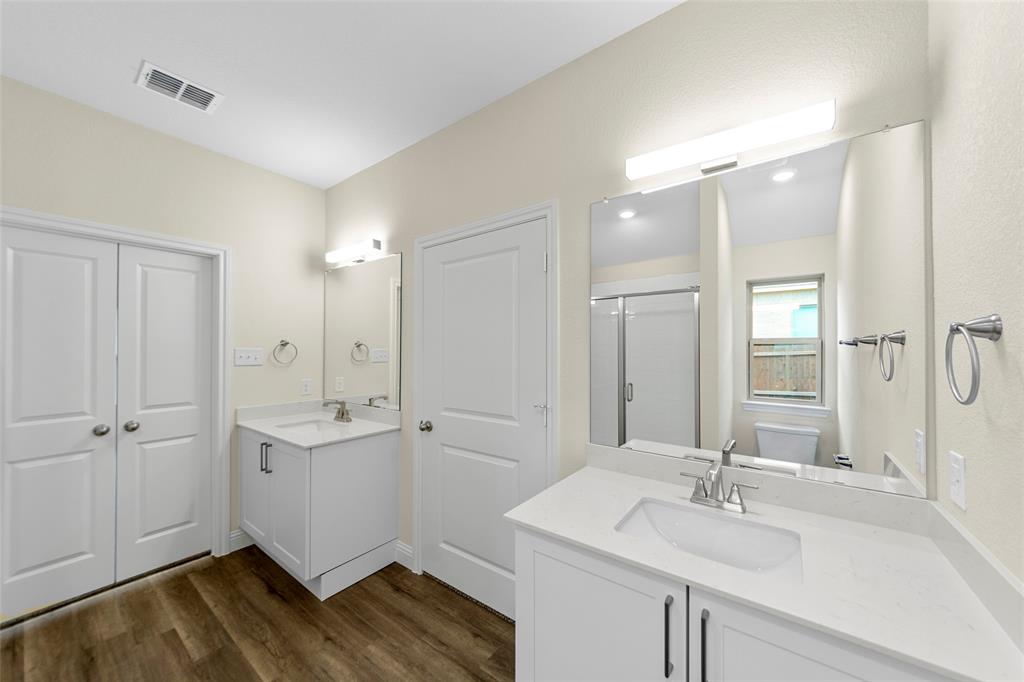 200 Pennington Road Josephine, TX 75173 - Photo 16 of 22 Dual white vanities with integrated sinks, each featuring a polished chrome faucet and quartz-finish countertop