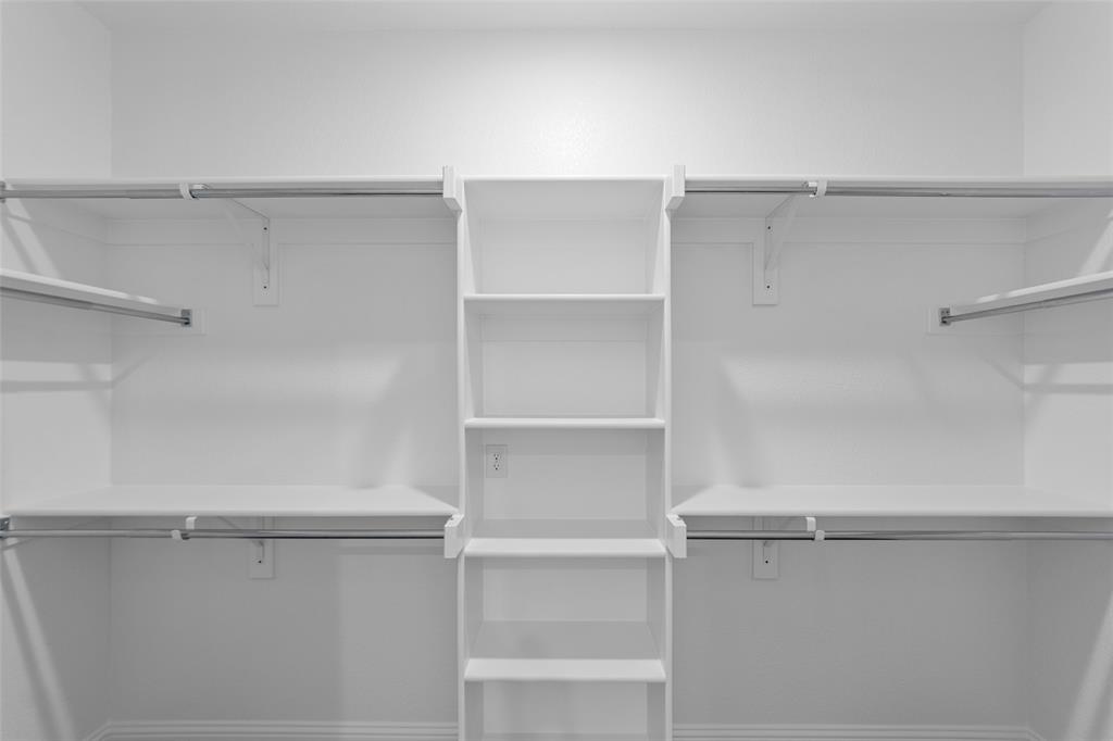 200 Pennington Road Josephine, TX 75173 - Photo 18 of 22 Built-in white shelving system with multiple shelves and hanging rods