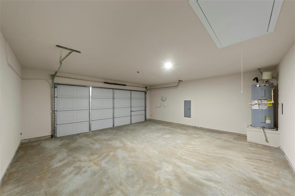 200 Pennington Road Josephine, TX 75173 - Photo 19 of 22 Two-car garage featuring a sectional overhead door, concrete flooring, recessed lighting, and a ceiling access panel