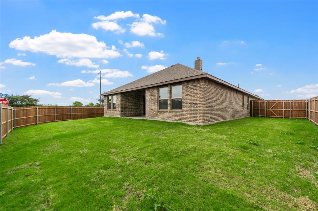 200 Pennington Road Josephine, TX 75173 - Photo 20 of 22 Spacious backyard featuring a full wood privacy fence and a brick-faced exterior
