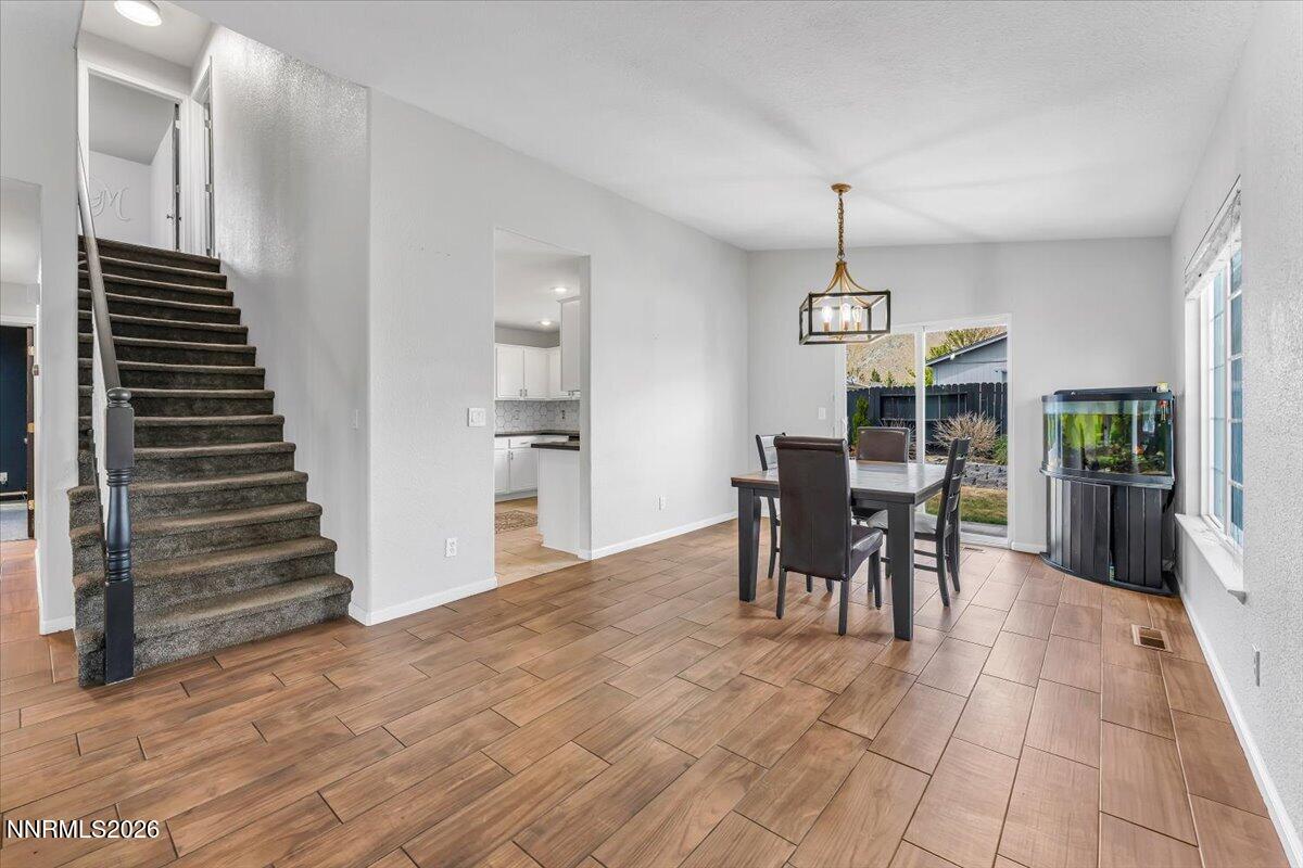 17725 Gingko Court Reno, NV 89508 - Photo 12 of 37 a view of a dining room with furniture and wooden floor