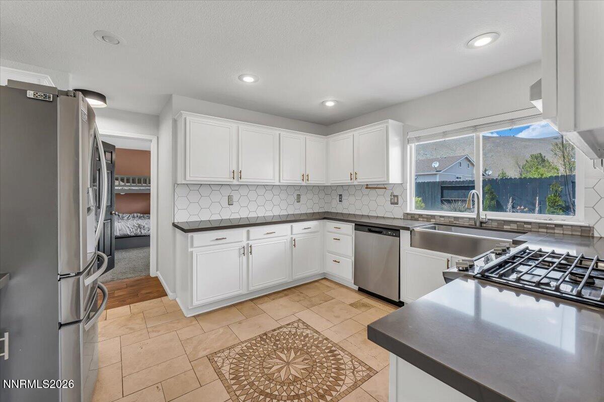 17725 Gingko Court Reno, NV 89508 - Photo 13 of 37 a kitchen with stainless steel appliances granite countertop a sink stove and refrigerator