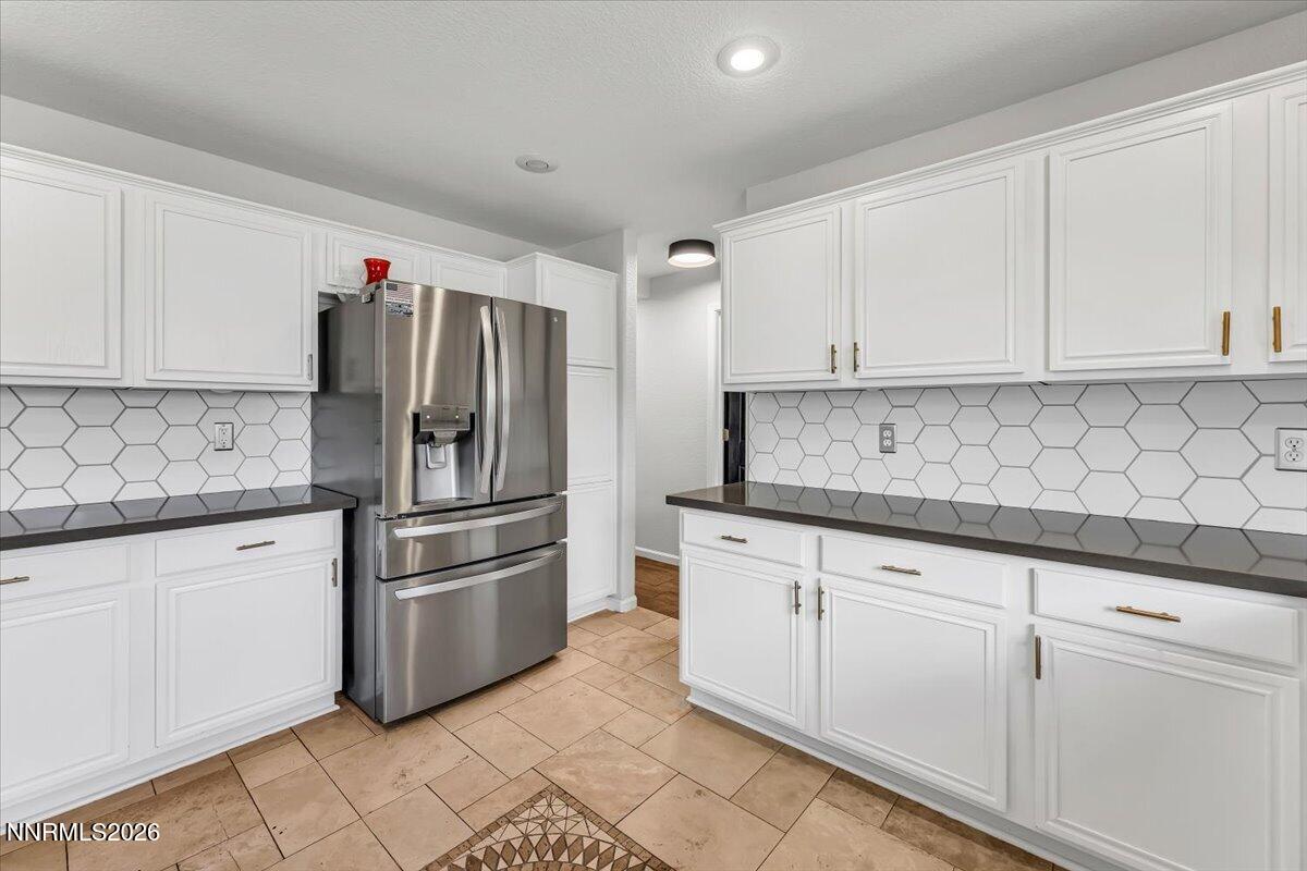 17725 Gingko Court Reno, NV 89508 - Photo 14 of 37 a kitchen with granite countertop white cabinets and stainless steel appliances