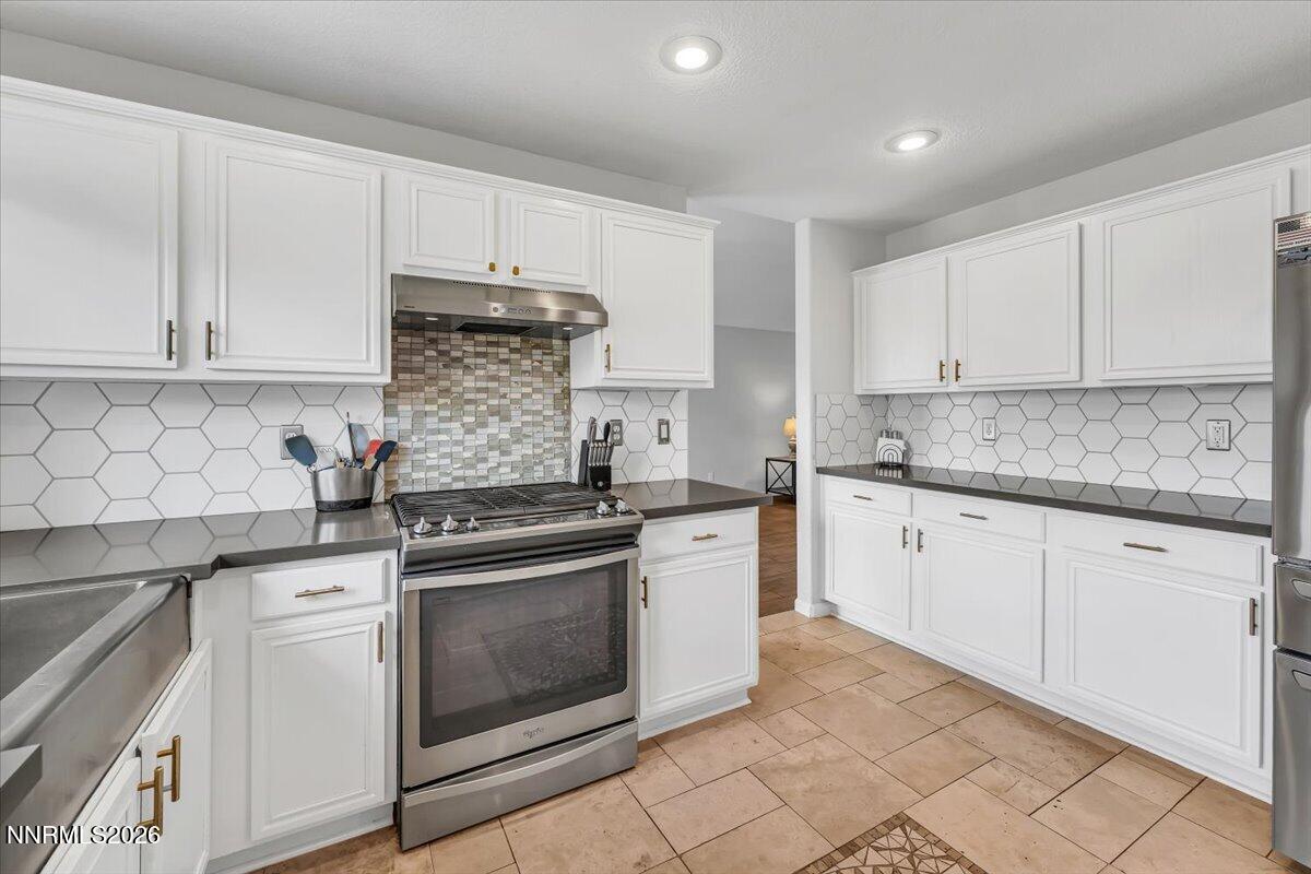 17725 Gingko Court Reno, NV 89508 - Photo 15 of 37 a kitchen with granite countertop white cabinets and white stainless steel appliances