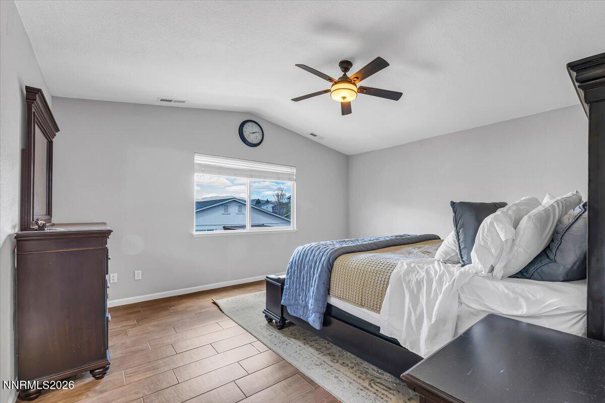 17725 Gingko Court Reno, NV 89508 - Photo 17 of 37 a bedroom with a bed and a chandelier