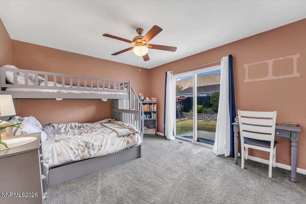17725 Gingko Court Reno, NV 89508 - Photo 18 of 37 a bedroom with a bed and a chandelier