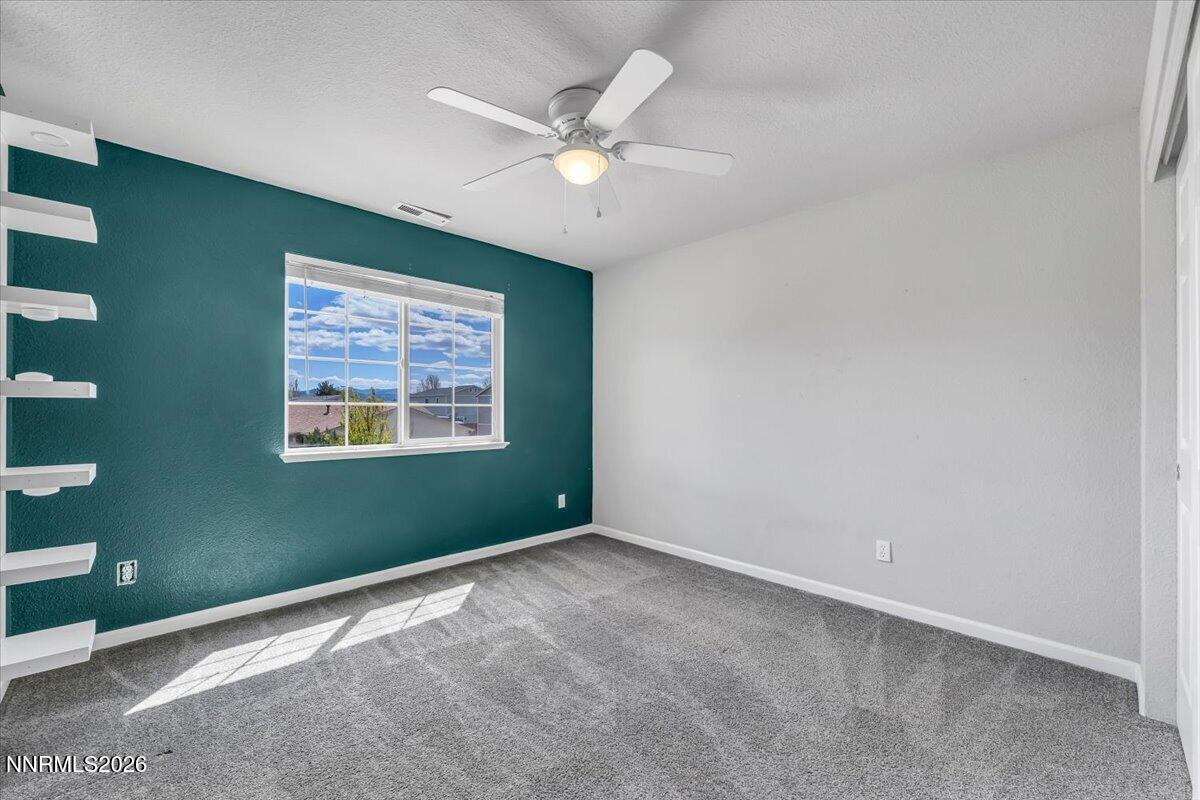17725 Gingko Court Reno, NV 89508 - Photo 24 of 37 an empty room with window and ceiling fan