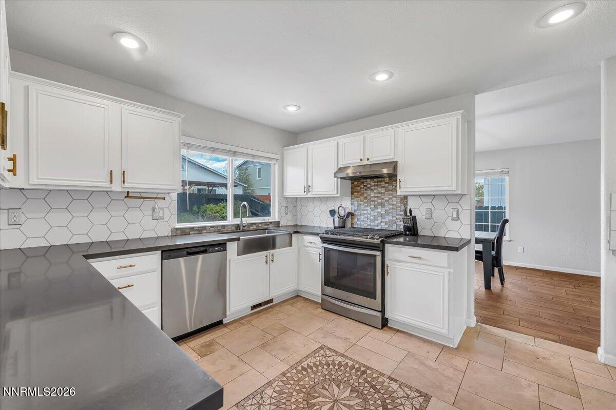 17725 Gingko Court Reno, NV 89508 - Photo 3 of 37 a kitchen with stainless steel appliances granite countertop a stove a sink and a microwave