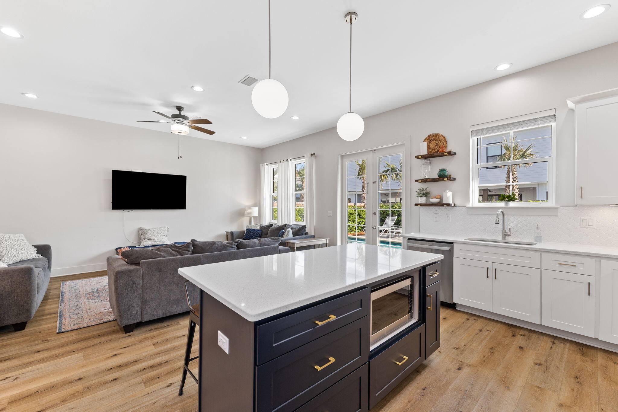 47 Ruth Street Miramar Beach, FL 32550 - Photo 20 of 63 a living room with stainless steel appliances kitchen island granite countertop a sink a stove and a wooden floors