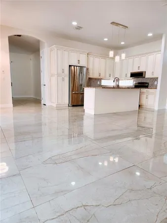 a view of a kitchen with cabinets and stainless steel appliances