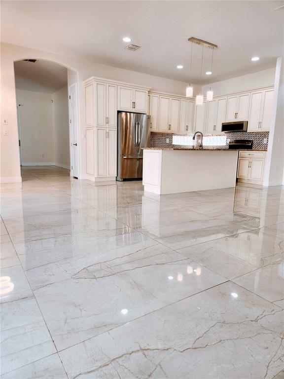 7190 Raymond Place Spring Hill, FL 34607 - Photo 12 of 41 a view of a kitchen with cabinets and stainless steel appliances