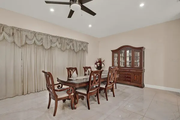 a dining room with furniture and window
