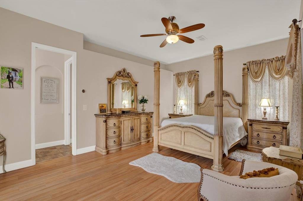 7190 Raymond Place Spring Hill, FL 34607 - Photo 20 of 41 a bedroom with a bed a window and a chandelier