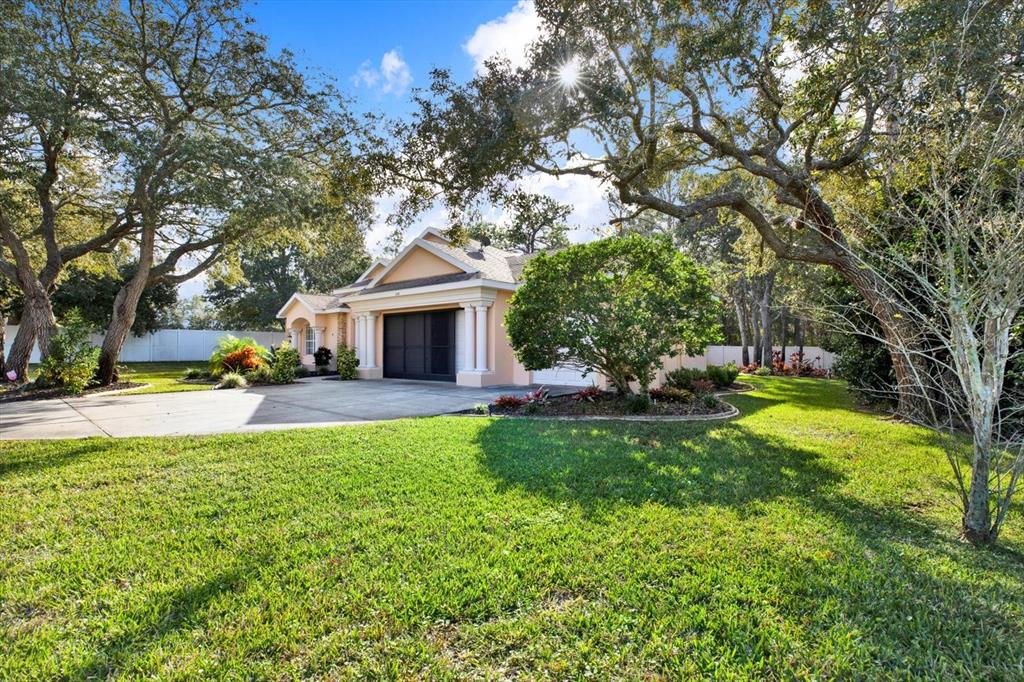 7190 Raymond Place Spring Hill, FL 34607 - Photo 2 of 41 a view of a house with pool and a bench