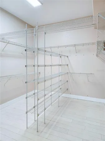 a bathroom with a granite countertop sink a mirror and a shower