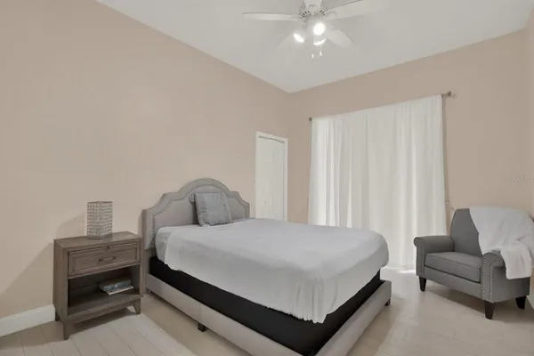 a bedroom with a bed and chair