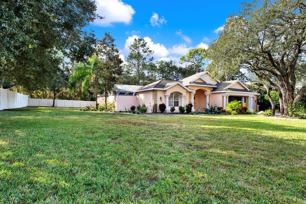 7190 Raymond Place Spring Hill, FL 34607 - Photo 3 of 41 a front view of a house with a yard