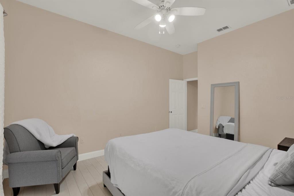 7190 Raymond Place Spring Hill, FL 34607 - Photo 31 of 41 a bedroom with a bed and chair