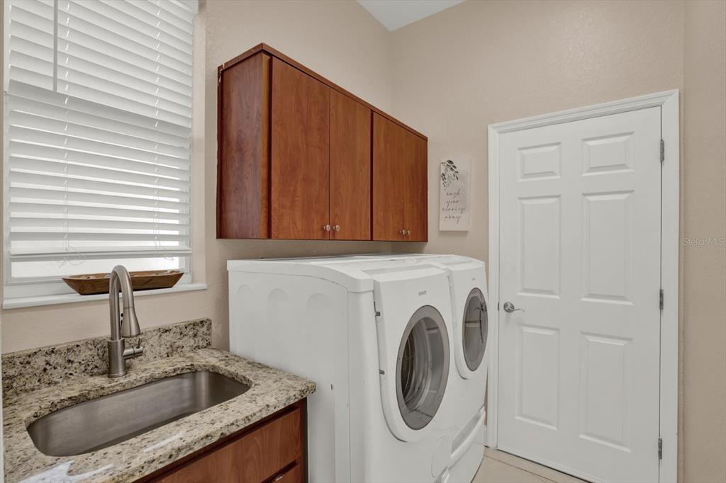 7190 Raymond Place Spring Hill, FL 34607 - Photo 32 of 41 a utility room with sink dryer and washer
