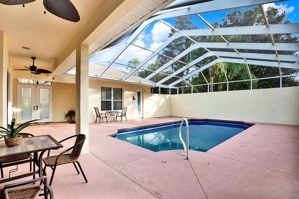 7190 Raymond Place Spring Hill, FL 34607 - Photo 33 of 41 a backyard of a house with table and chairs