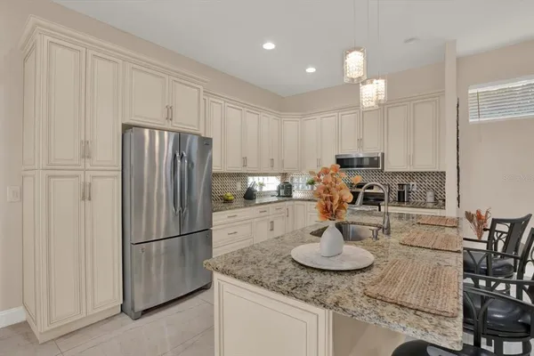 a kitchen with refrigerator and cabinets