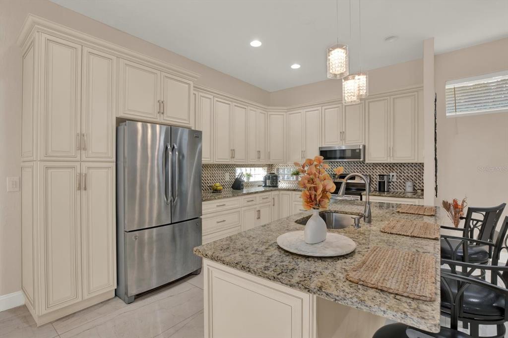 7190 Raymond Place Spring Hill, FL 34607 - Photo 4 of 41 a kitchen with refrigerator and cabinets