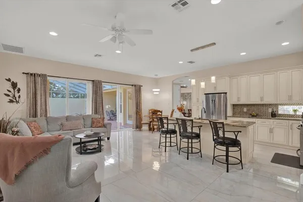 a large room with lots of white furniture and view living room