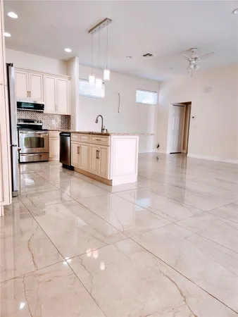 a large kitchen with stainless steel appliances and cabinets