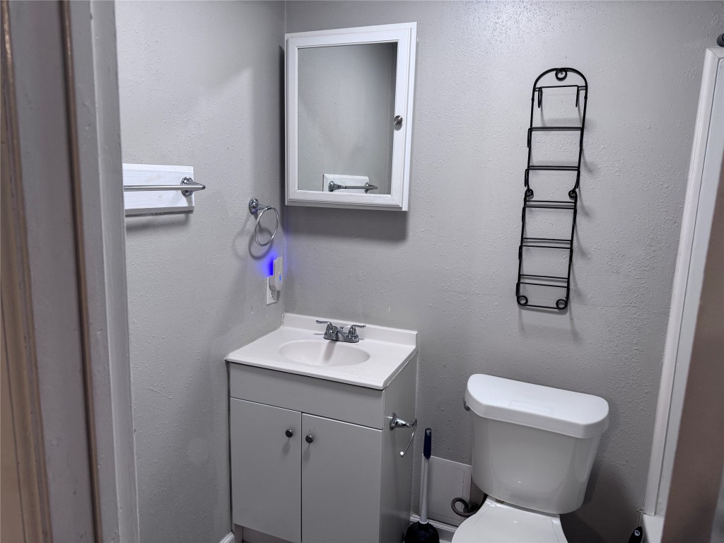901 Parmer Avenue, Unit 3 Killeen, TX 76541 - Photo 11 of 12 a bathroom with a toilet sink vanity and mirror