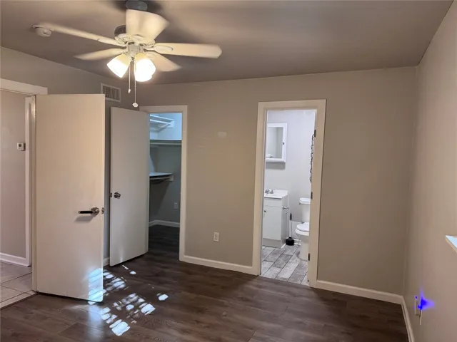 wooden floor in an empty room with a mirror